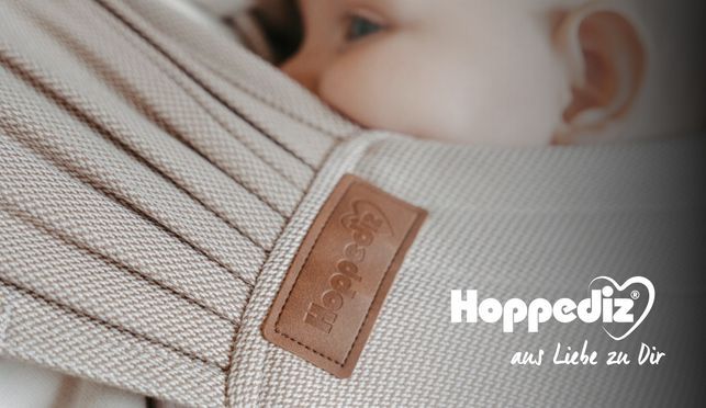 Hoppediz Hop Tye Advanced – Die flexible Babytrage für Dein Neugeborenes und Kleinkind.