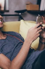 Junge hört Musik über Smartphone.
