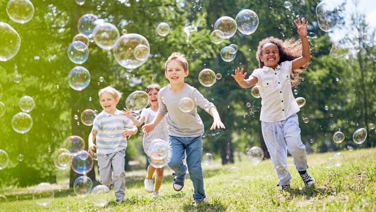 Kinder beim Seifenblasen-Fangen fotografieren