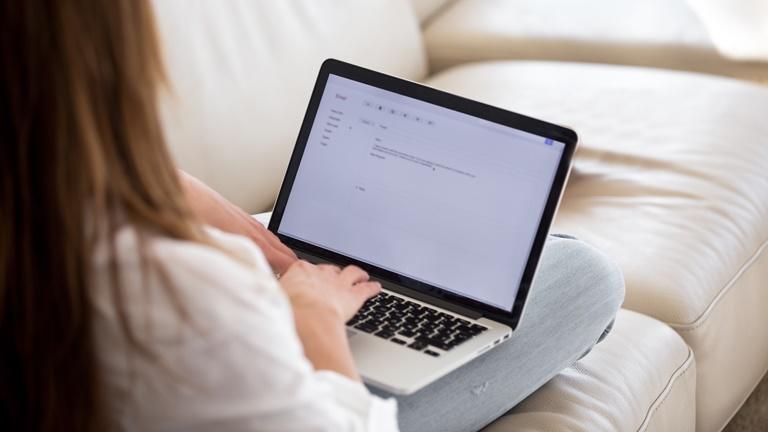 Frau exportiert Outlook-Kontakte auf einem Laptop Frau exportiert Outlook-Kontakte auf einem Laptop
