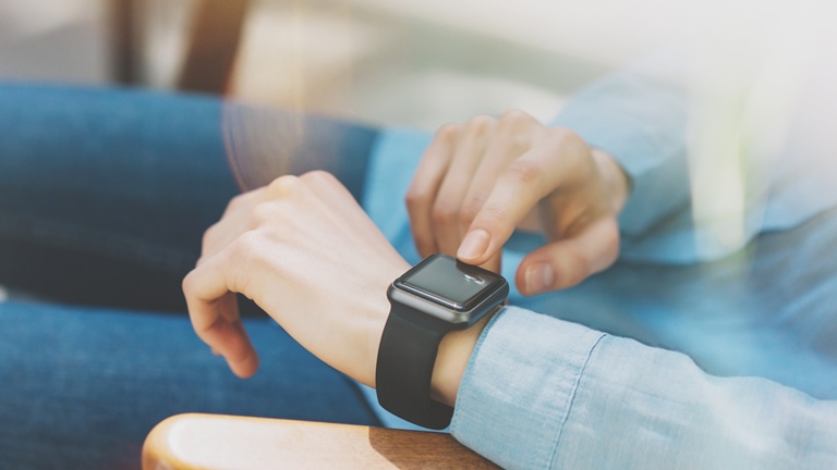 WhatsApp auf der Fitbit nutzen: So empfängst du Nachrichten Frau tippt auf Smartwatch