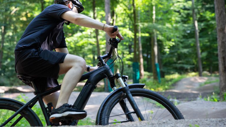 E-MTBs Eine Person fährt mit einem E-MTB durch eine Steilkurve.