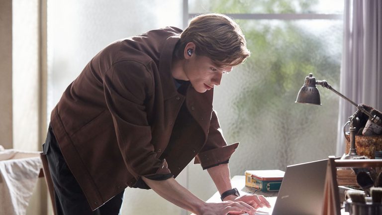Samsung Galaxy Buds Pro Eine Person trägt die Galaxy Buds Pro und beugt sich über einen Laptop.