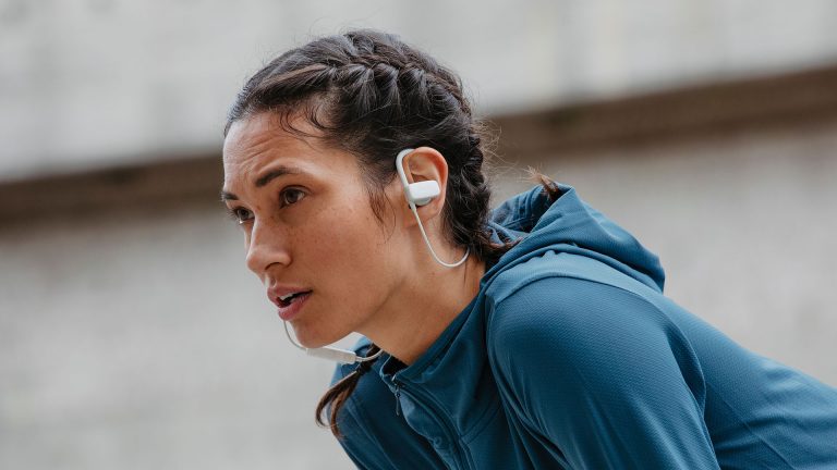 Eine Person in Sportbekleidung trägt die Teufel Airy Sports in den Ohren.