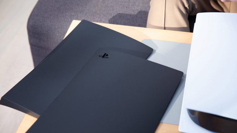 PlayStation 5: So wechselst du die Seitenteile Zwei Seitenteile in Schwarz liegen neben einer PlayStation 5.