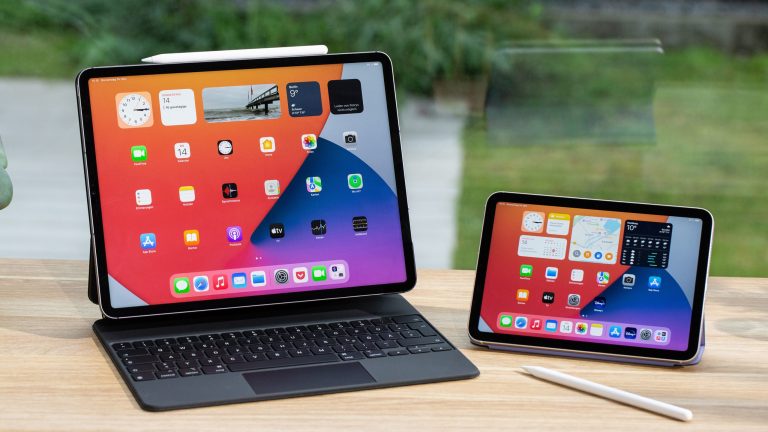 Eine iPad Pro steht aufgeklappt auf einem Magic Keyboard neben einem iPad mini.