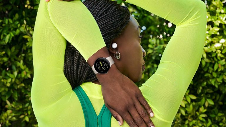 Neue Google Klassiker, Google Pixel 9, Watch 3 und Buds Pro 2 Eine Person steht mit dem Rücken zur Kamera und streckt einen Arm über den Kopf nach hinten. Sie trägt eine Google Watch 3 am Handgelenk und die Buds Pro 2 im Ohr.