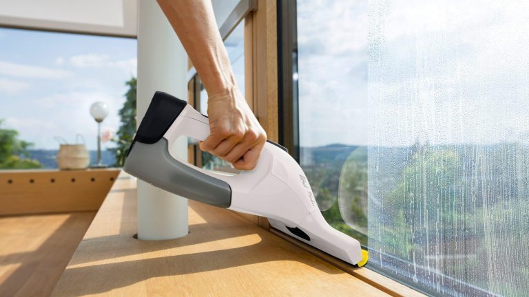 Fenstersauger, 6 Geräte für streifenfreie Sauberkeit Eine Person zieht mit einem Kärcher WV 7 ein eingeschäumtes Fenster bis zum Boden ab.