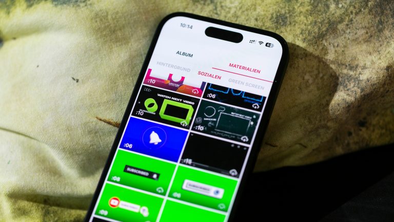Videos bearbeiten, Apps zum Schneiden, Bearbeiten und Co. Ein Smartphone liegt auf einem Kissen. Auf dem Bildschirm eine Auswahl an Vorlagen in einer Video-Editor-App.