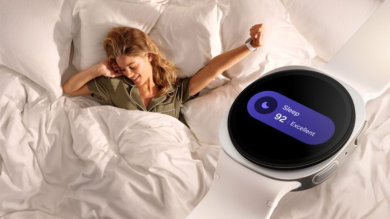 Eine Person liegt in einem Bett und streckt sich, als würde sie gerade aufwachen. Am Handgelenk trägt sie die Watch8.